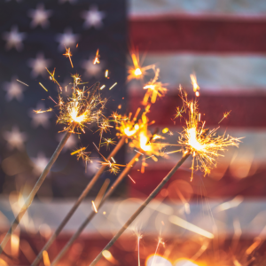 sparklers in front of a flag